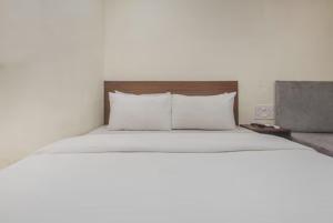 a large bed with two pillows at Uma Residency - Chakala in Mumbai