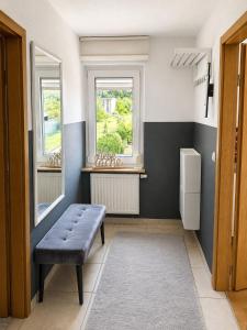 a room with a bench and two windows at Ferienwohnung AM PETER in Gotha