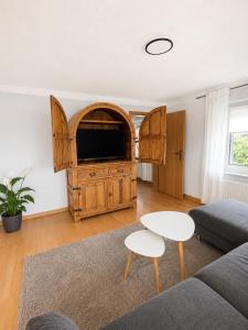 a living room with a couch and a tv at Ferienwohnung AM PETER in Gotha