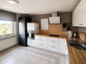 a kitchen with white cabinets and a sink at Ferienwohnung AM PETER in Gotha