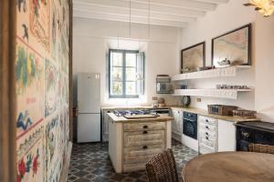 a kitchen with a refrigerator and a table at Villa Station by Cassai in Ses Salines