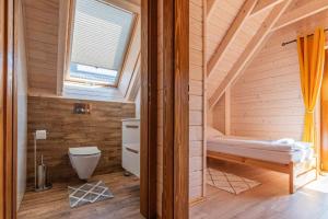 a small bathroom with a toilet and a window at Osada Gorczański Zakątek in Nowy Targ +11 photos