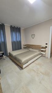 a bedroom with a large bed in a room at B&B House Novara in Novara