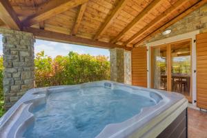 a jacuzzi tub in a house with a patio at Villa Dol in Buzet