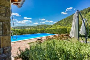 a villa with a swimming pool and mountains in the background at Villa Dol in Buzet +37 photos