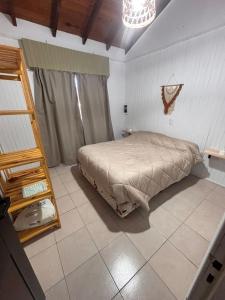 a bedroom with a bed and a mirror in it at Casa en Berazategui in Plátanos +8 photos
