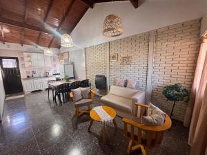 a living room with a couch and chairs and a table at Casa en Berazategui in Plátanos