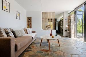 a living room with a couch and a table at Lemon Tree Villa in Chalkida +18 photos