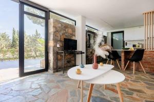 a living room with a table and chairs at Lemon Tree Villa in Chalkida