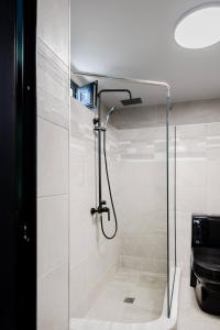 a shower with a glass door in a bathroom at Lemon Tree Villa in Chalkida