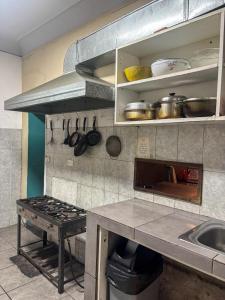 a kitchen with a sink and a stove in it at Hostel rivendell lima in Lima