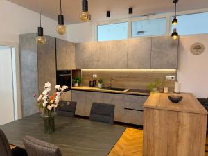 a kitchen with a table with flowers on it at The White House Split in Split
