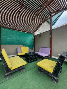 a room with two beds and a table and chairs at Hostel rivendell lima in Lima