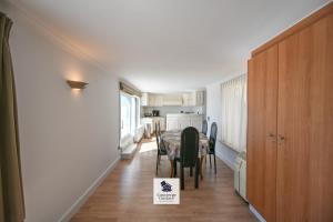 a kitchen and dining room with a table and chairs at Drakkar in Wenduine