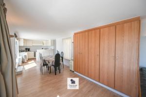 a dining room with a table and a wooden cabinet at Drakkar in Wenduine