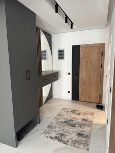 a hallway with a door and a rug at AD Home in Bar +5 photos