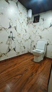 a bathroom with a toilet and a sink at Shelby Pawana lake Cottages and Camping in Lonavala +63 photos