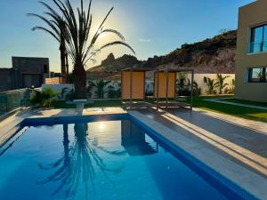 a swimming pool in front of a house at Prestige Pool Retreat in Hammamet