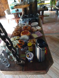 a table full of food on top of a stove at Pousada Canto do Sossego in Brumadinho +20 photos