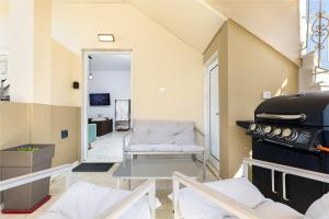 a living room with a couch and a stove at Achilleas Deluxe House-Jacuzzi - BBQ in Kotsianá