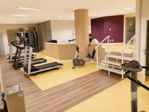 a gym with treadmills and machines in a room at Apartamento no Hotel Prinz in Joinville