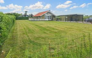a large yard with a house and a fence at 3 Bedroom Amazing Home In Haderslev in Haderslev +15 photos