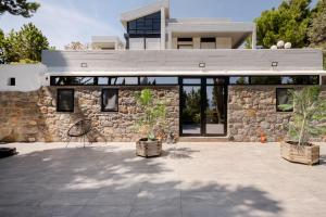 a stone building with two potted plants in front of it at Lemon Tree Villa in Chalkida