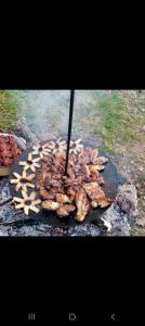 a bunch of food cooking on a grill at Casa Verde in Vrîncioaia Negrileşti