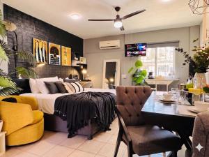 a bedroom with a large bed and a dining room at Polly's Home Boutique GuestHouse & Private Suites in Aralias in Puerto Vallarta