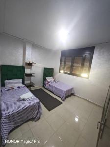 a room with two beds in a room at Ouida App in Oujda +7 photos
