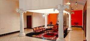 a living room with a couch and chairs in a room at Sun Private Pool Villa in Puducherry Airpoert