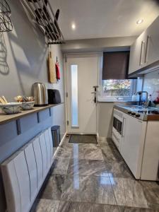 a small kitchen with a sink and a stove at Art House in Portsmouth
