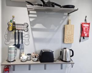 a shelf in a kitchen with pots and pans at Art House in Portsmouth
