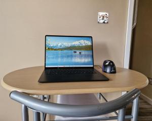 a laptop computer sitting on a table with a mouse at Art House in Portsmouth