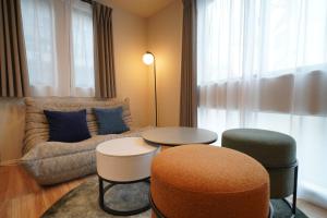 a living room with a couch and two tables at LinksHotel 西荻窪 in Ogikubo