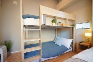 a bunk bed with a blue pillow in a bedroom at LinksHotel 西荻窪 in Ogikubo