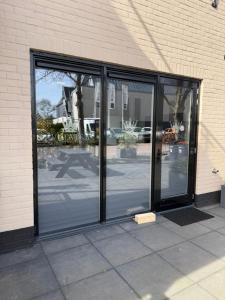 an entrance to a building with revolving glass doors at Villa B&B Bovenkarspel in Bovenkarspel