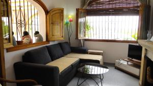 a living room with a couch and a tv at El Rafalet in Jávea