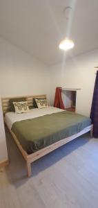 a bedroom with a wooden bed in a room at Duplex de l'abbaye in Pébrac