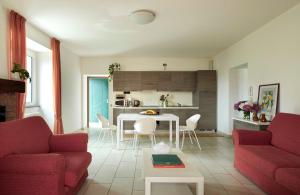 a living room with a couch and a table at Sunny View Lake Como Apartment- Trilo in Consiglio di Rumo