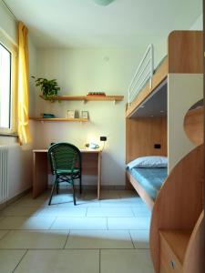 a room with a desk and a bed and a chair at Sunny View Lake Como Apartment- Trilo in Consiglio di Rumo