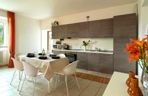 a kitchen with a table and chairs in a room at Sunny View Lake Como Apartment- Trilo in Consiglio di Rumo