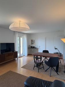 a living room with a wooden table and chairs at Schöne Aussicht in Idar-Oberstein