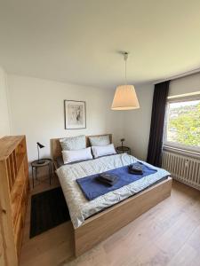 a bedroom with a bed with a blue blanket on it at Schöne Aussicht in Idar-Oberstein
