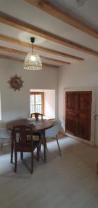a dining room with a table and a boat in a room at Duplex de l'abbaye in Pébrac