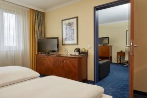 Ένα ή περισσότερα κρεβάτια σε δωμάτιο στο H4 Hotel Kassel +66 φωτογραφίες