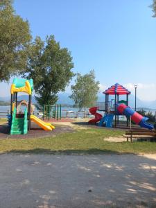 a park with a playground with slides and a slideintend at Residence agli Oleandri in Manerba del Garda