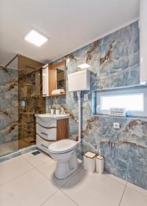 a bathroom with a toilet and a sink at Evergreen Escape Apartment in Užice