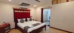 a bedroom with a bed and a red curtain at Sun Private Pool Villa in Puducherry Airpoert +48 photos
