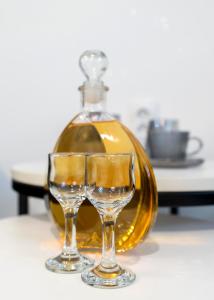 a wine glass sitting next to a bottle at Evergreen Escape Apartment in Užice